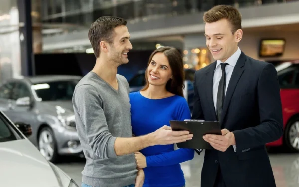 A man and woman talking to two men in front of them.